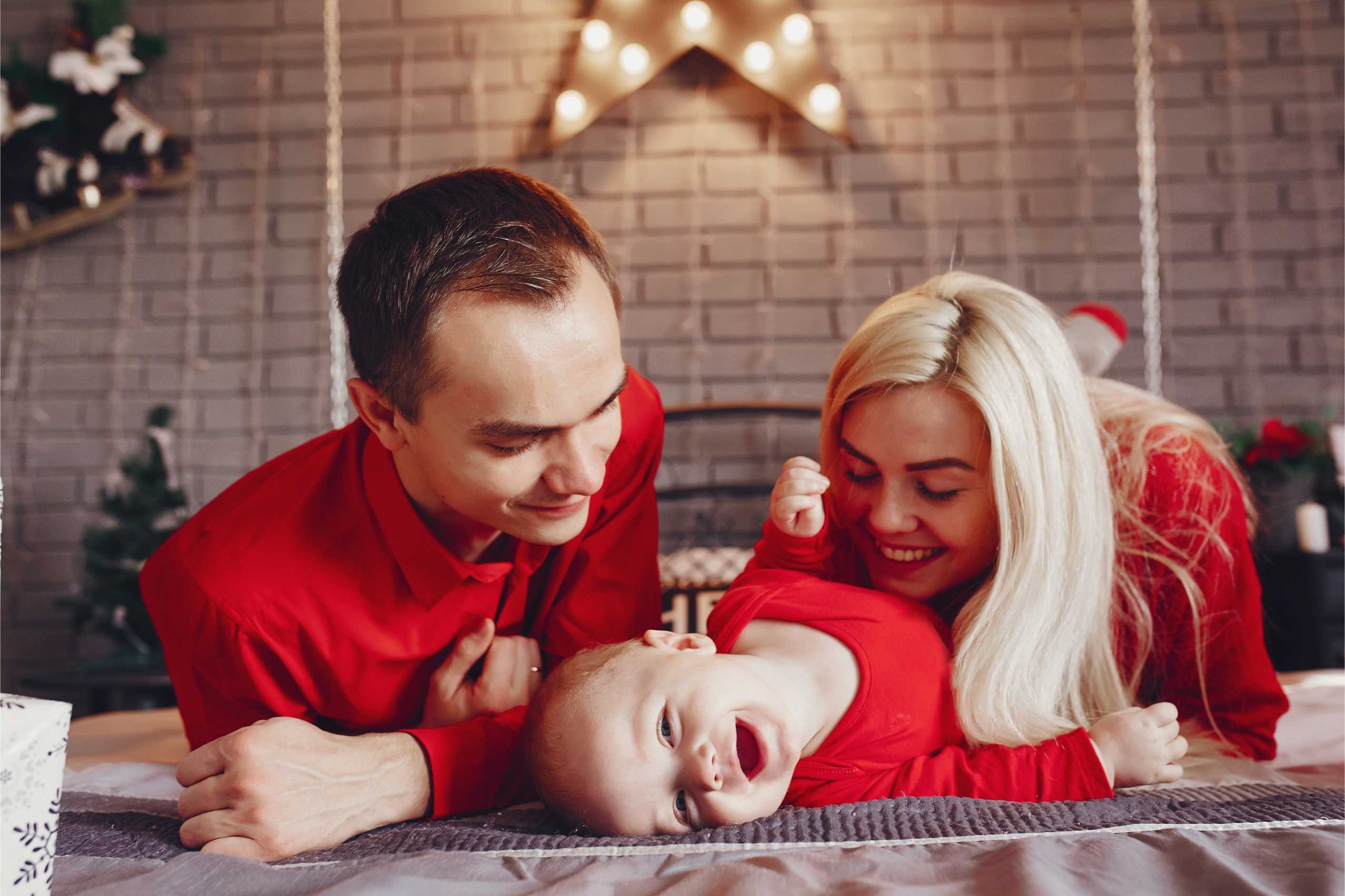 Young parents interacting with their baby to build emotional bonding at home.